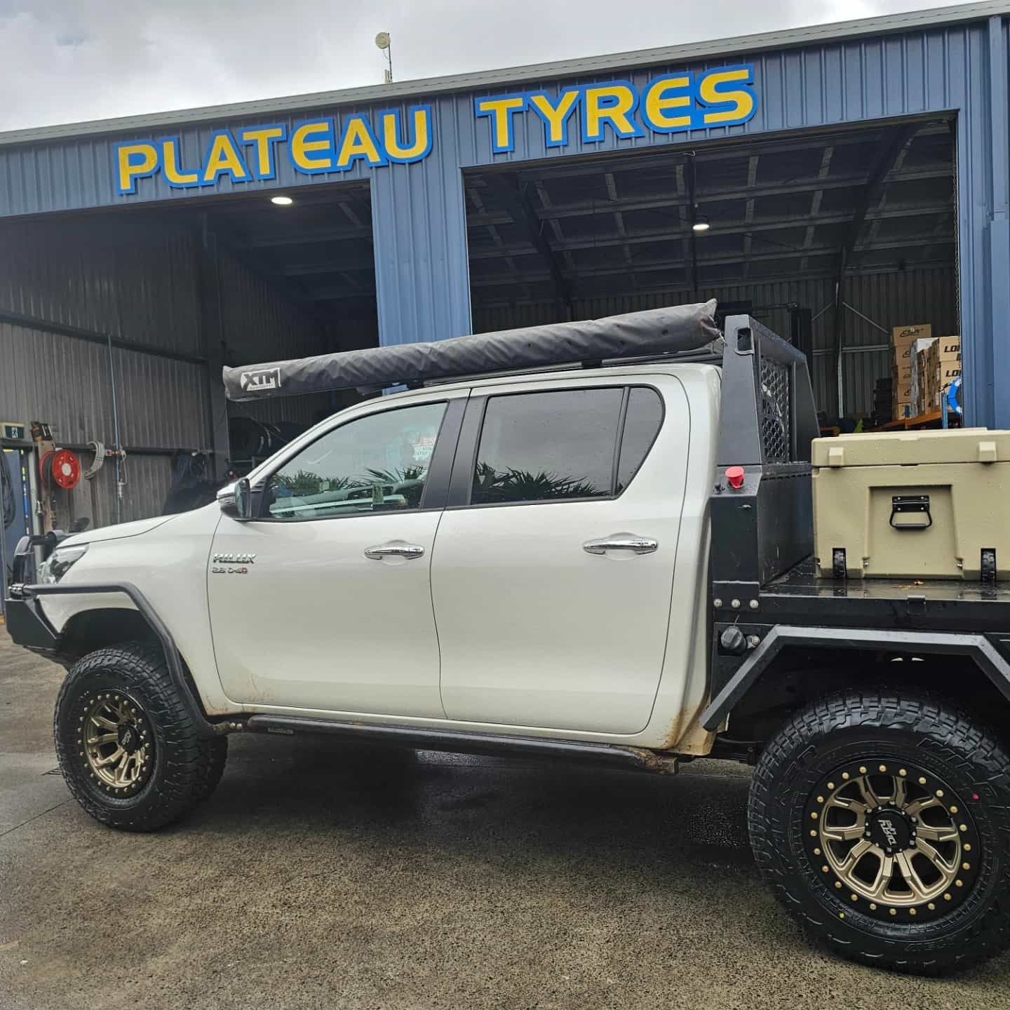 White Pickup Truck With Off-road Tyres Parked at Plateau Tyres — Plateau Tyres in Wollongbar, NSW