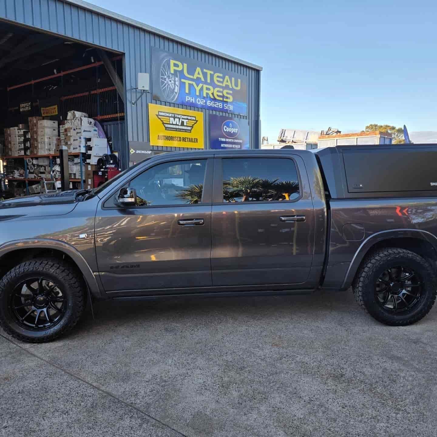 Gray Pickup Truck With Black Wheels and Canopy Parked Outside — Plateau Tyres in Goonellabah, NSW