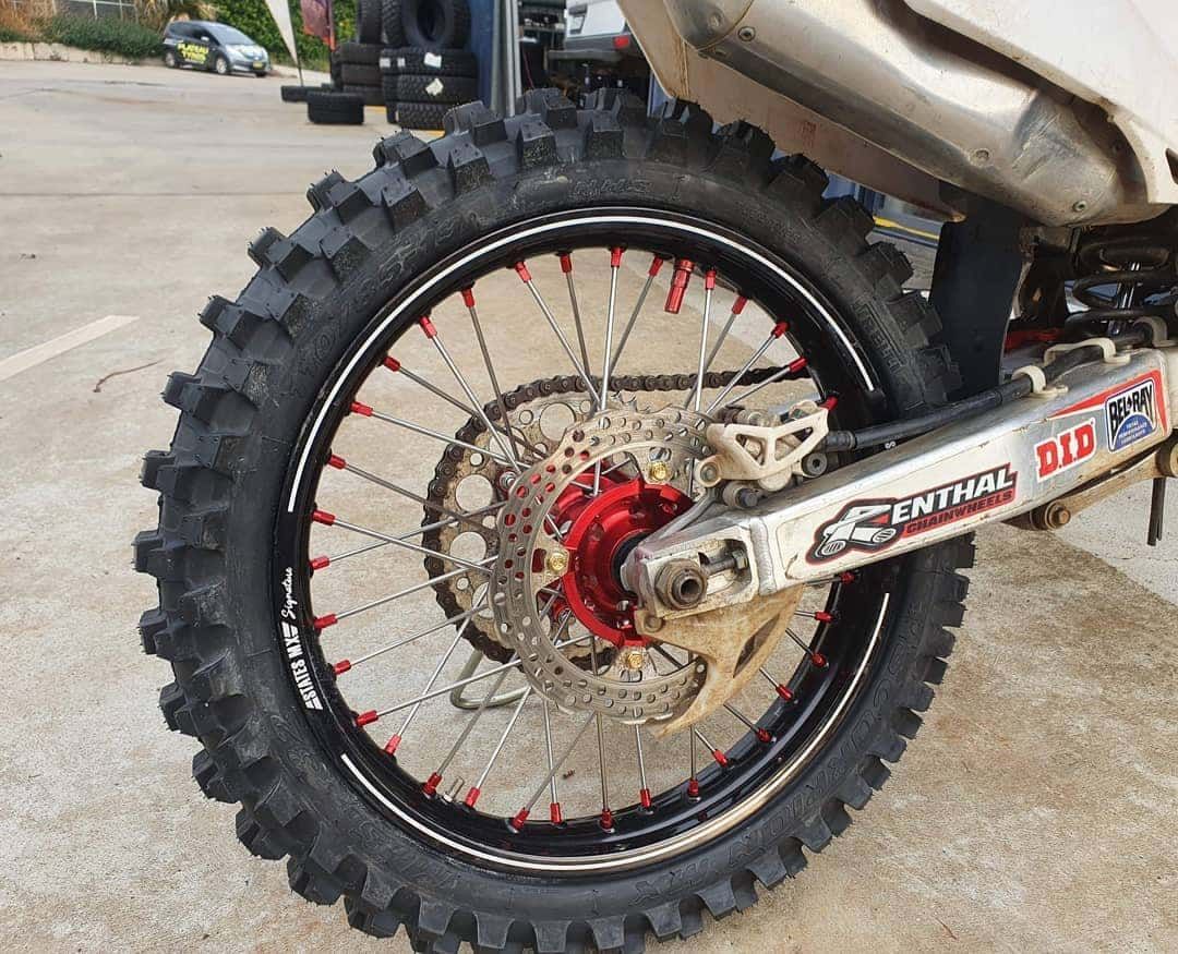 Rear Wheel of a Dirt Bike With a Black Tyre — Plateau Tyres in Alstonville, NSW