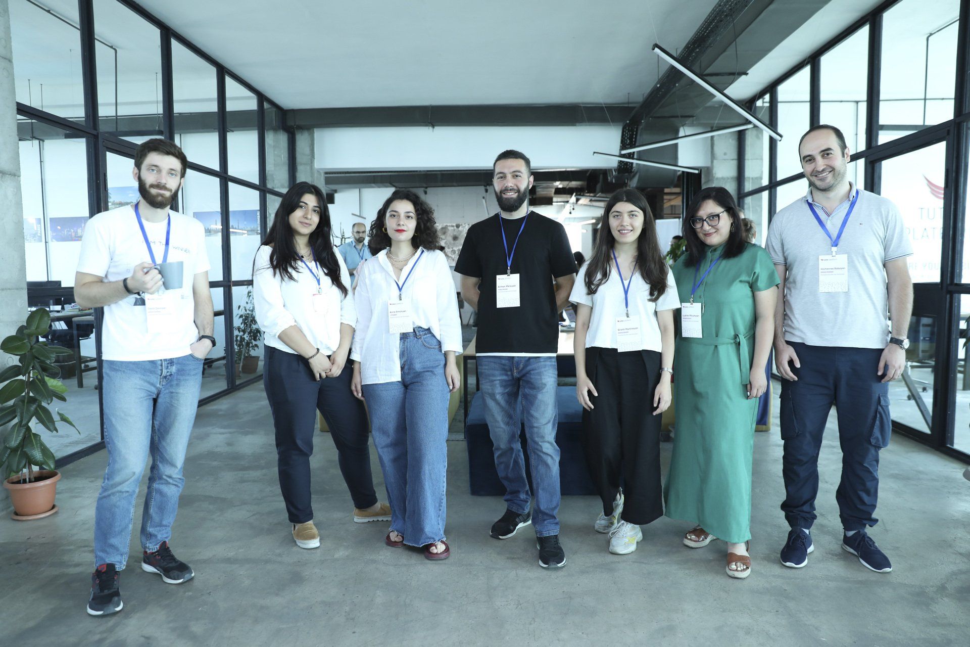 A group of people are posing for a picture in an office.