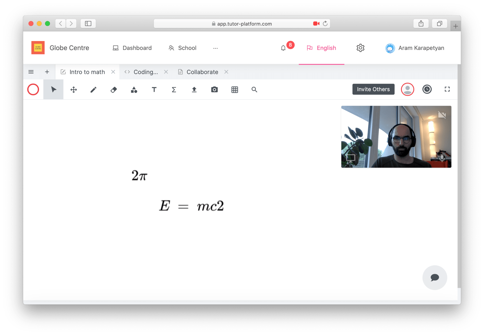 A computer screen shows a man talking on a video call.