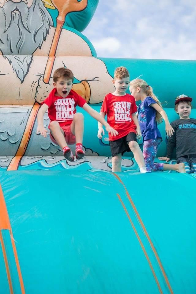 A Group Of Children Are Playing On A Bouncy House — Rides N Slides In Townsville, QLD