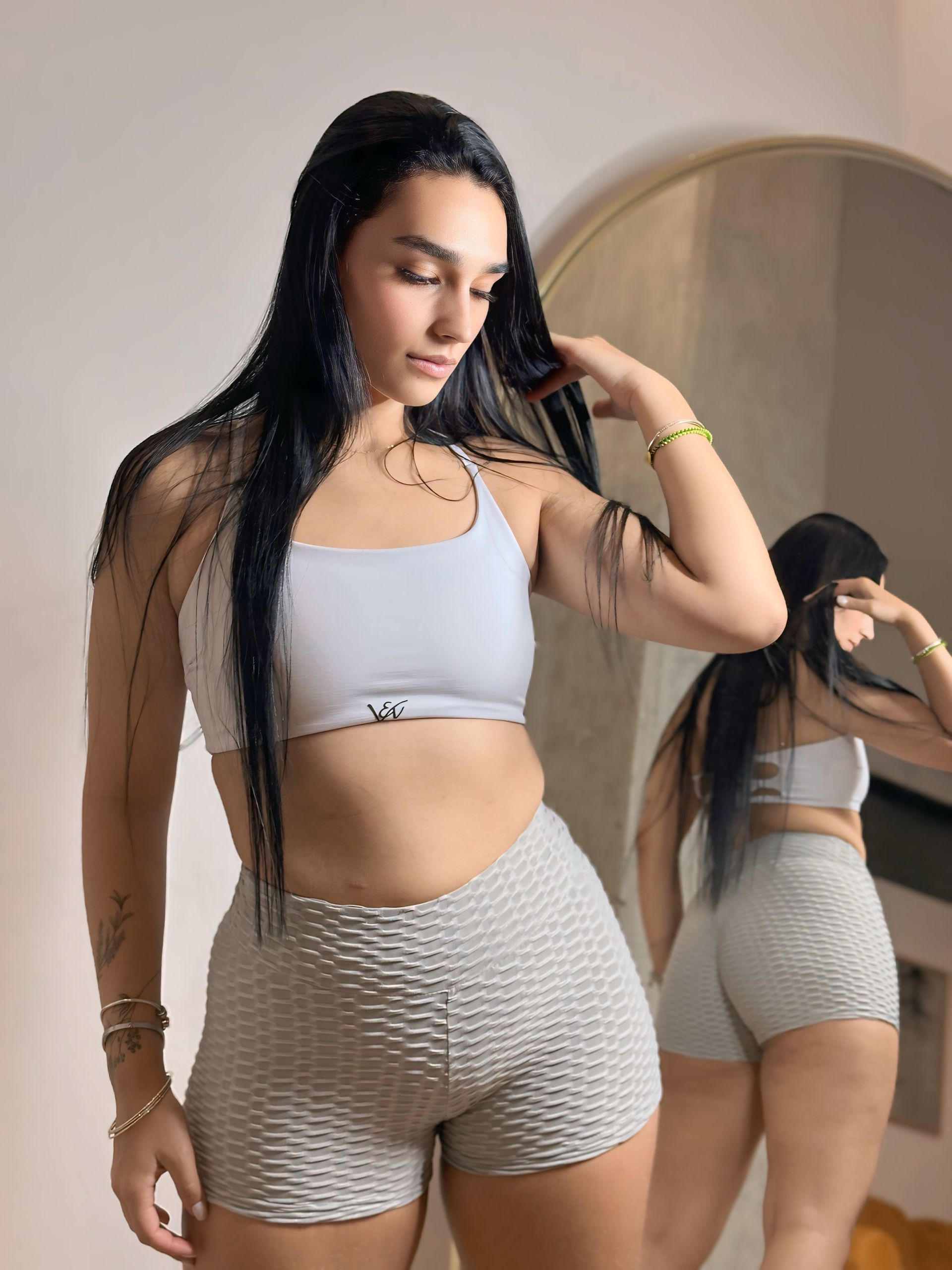 A woman is taking a picture of herself in front of a mirror.