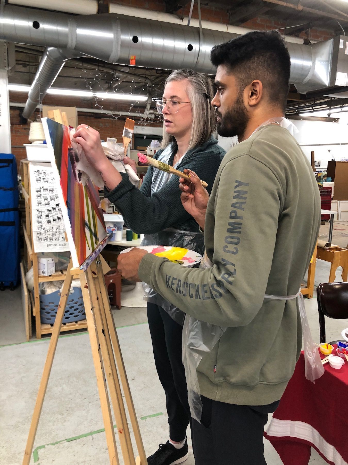 focused couple working on a canvas together