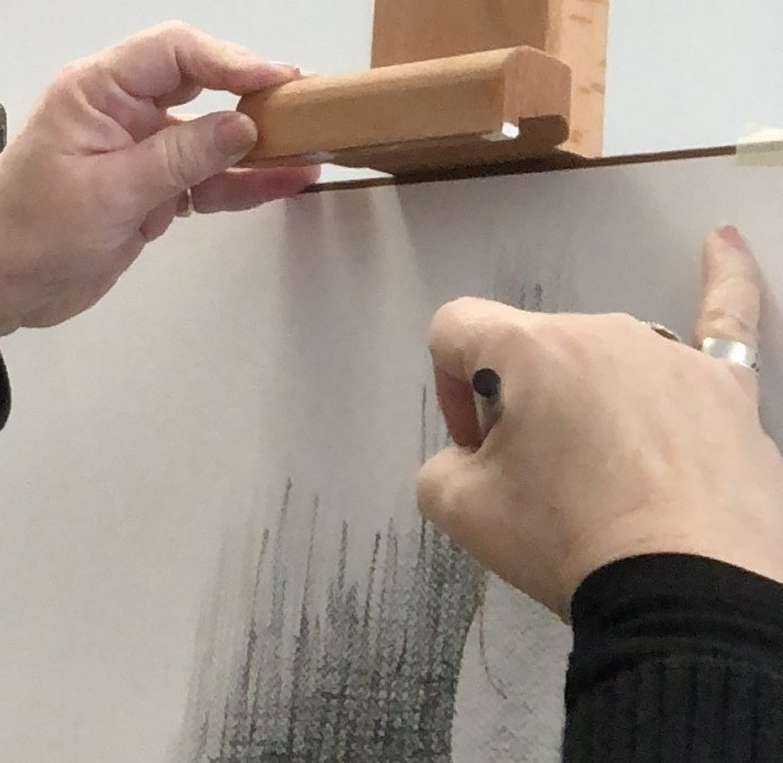 close up of hands drawing on paper