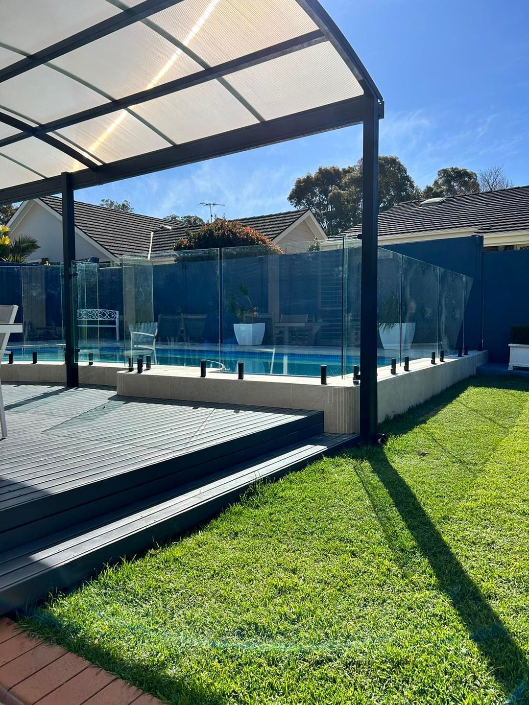 A Backyard Pool With a Glass Fence — ClearView Glass Pool Fencing In Roselands, NSW
