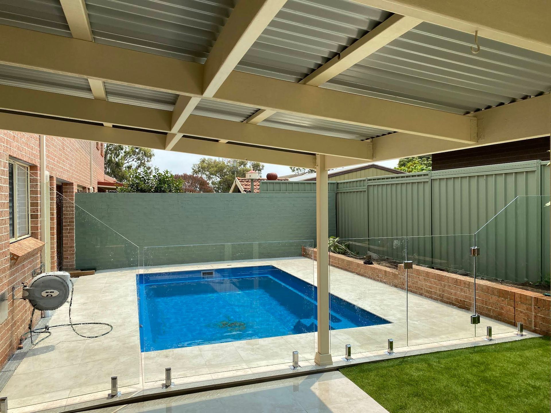 Covered Backyard Pool With Blue Water — ClearView Glass Pool Fencing In Parramatta, NSW