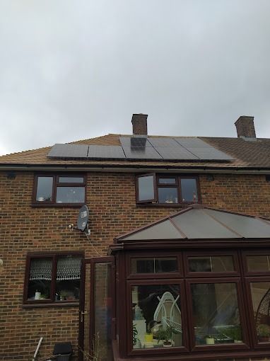 A brick house with solar panels on the roof