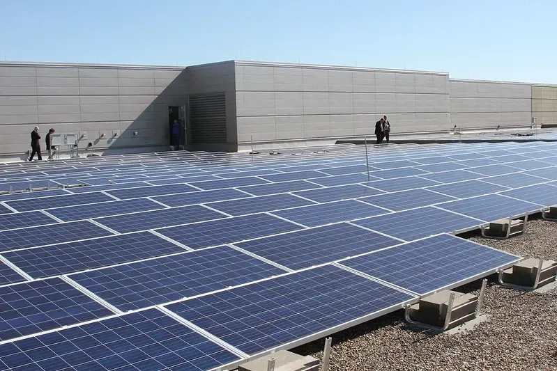 A brick house with solar panels on the roof.