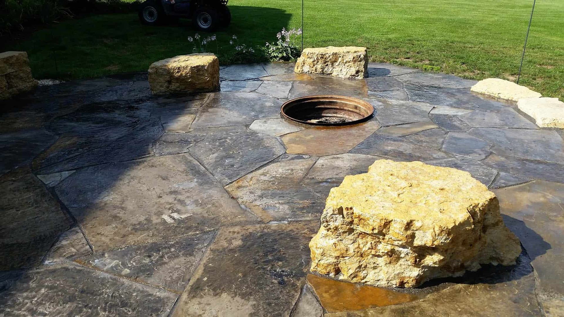There is a fire pit in the middle of the patio.