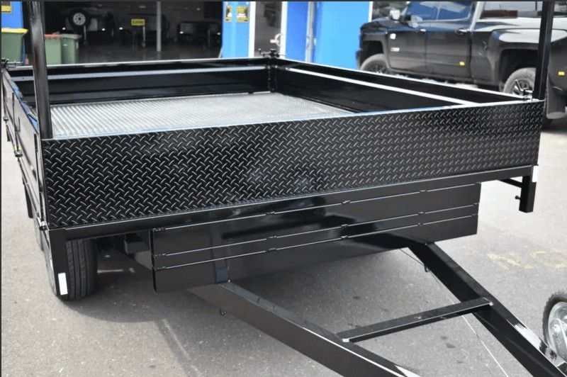 A Black Trailer is Parked on the Side of the Road — Voyager Trailers in Howard Springs, NT