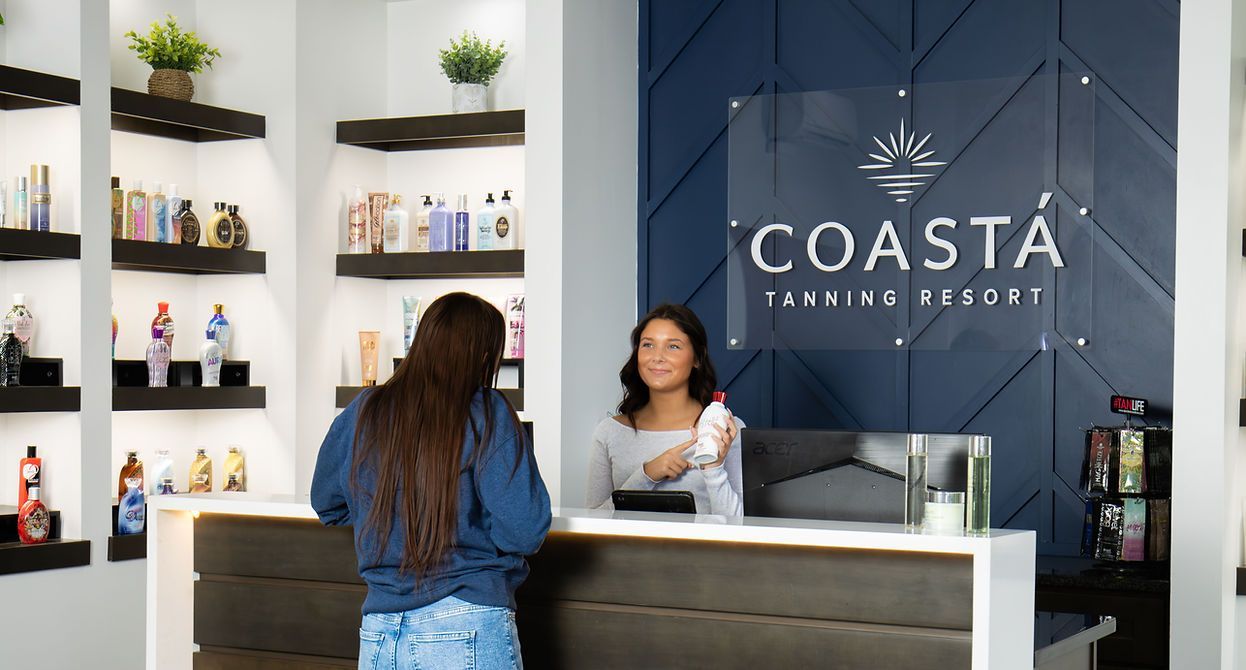 Reception desk at Coast Banking Resort with staff assisting a customer in a modern lobby