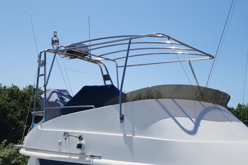 A white boat with a canopy on top of it