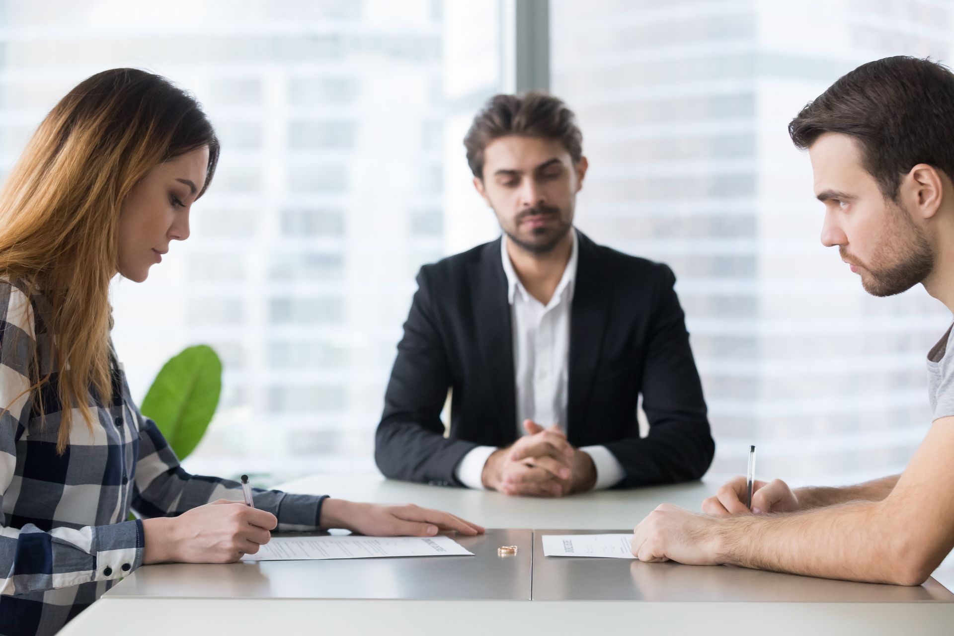 Divorce lawyer guiding clients through paperwork and mediation.
