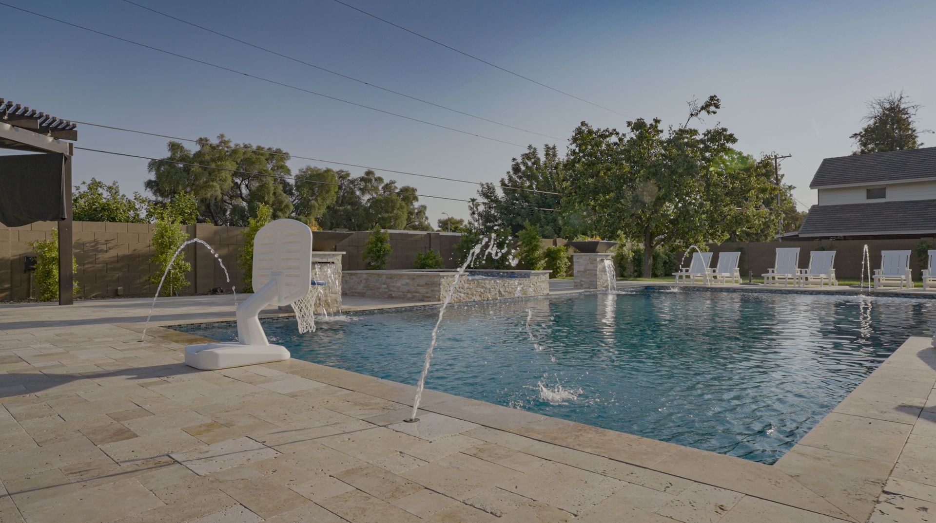 A large swimming pool with a fountain in the middle of it.