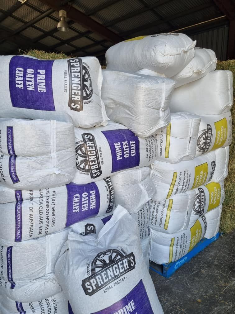 A Stack Of Bags Of Springer 's Prime Hay — SF Produce In Proserpine, QLD