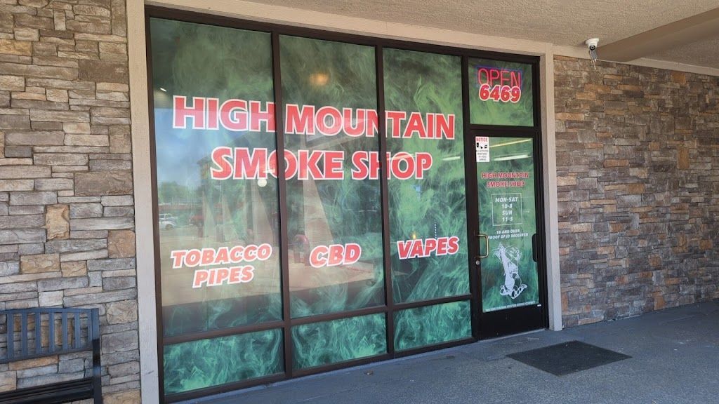 A store front with a sign that says high mountain smoke shop