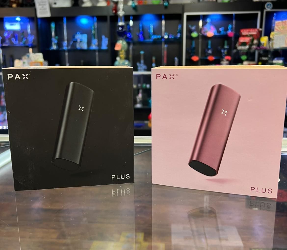 Two boxes of pax vaporizers are sitting on a table.