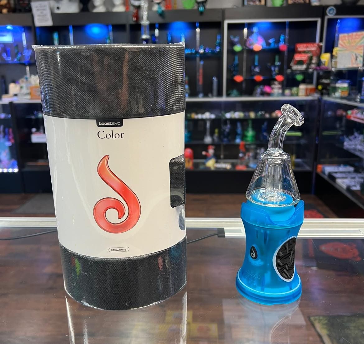 A bottle and a pipe are sitting on a table in a store.