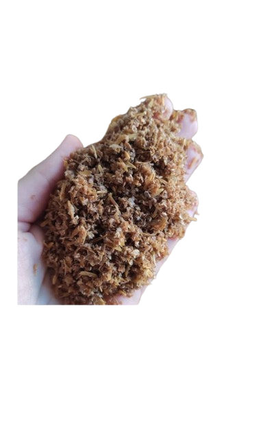 Hand holding a clump of brown, shredded food.