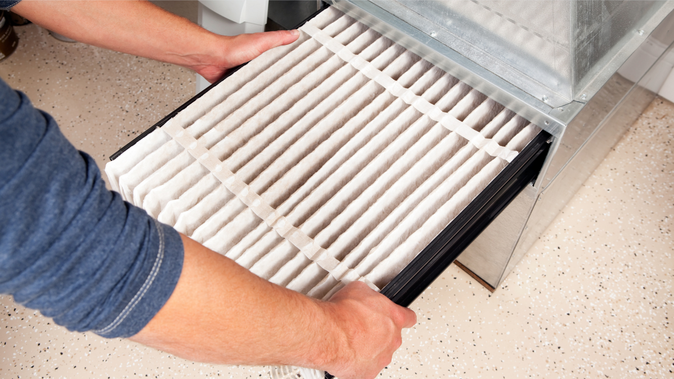 Hands pulling a white slatted tray from a metal rack on a beige floor