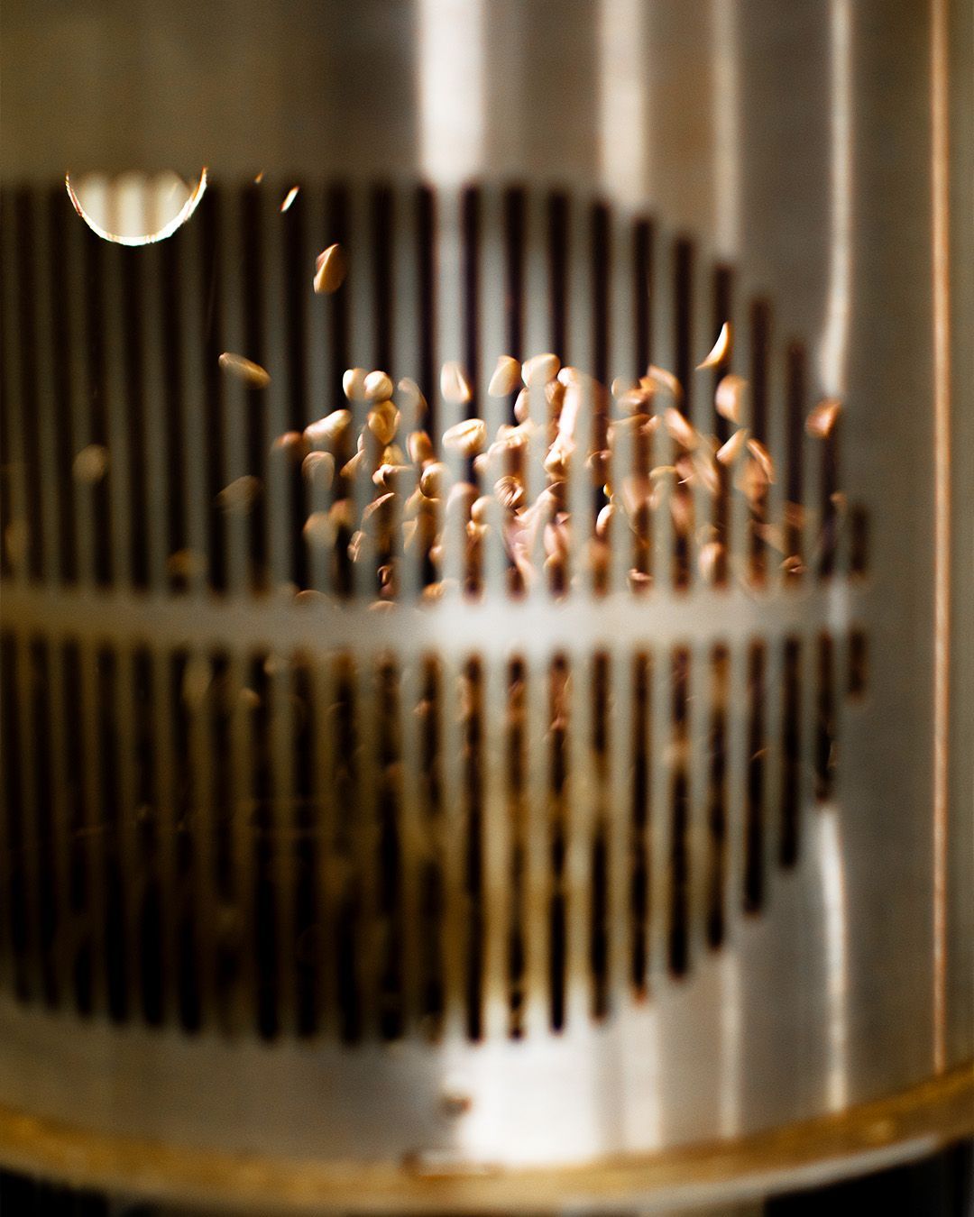 A close up of coffee beans being roasted in an air roaster