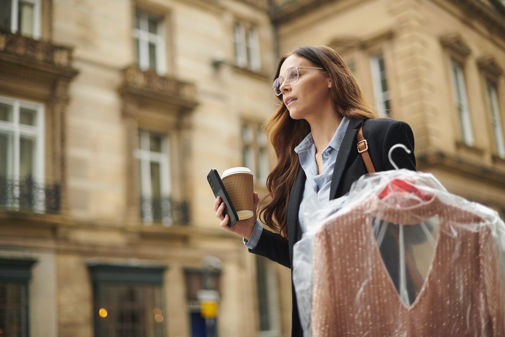 Woman Holding Clean Clothes — Canandaigua, NY — Star Cleaners Woman Holding Clean Clothes — Canandaigua, NY — Star Cleaners