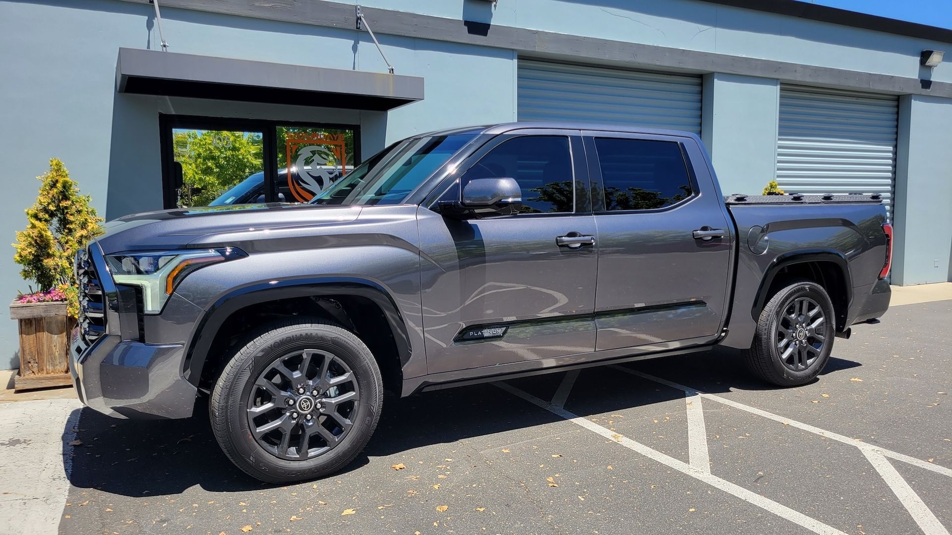 A toyota tundra is parked in a parking lot in front of a building.