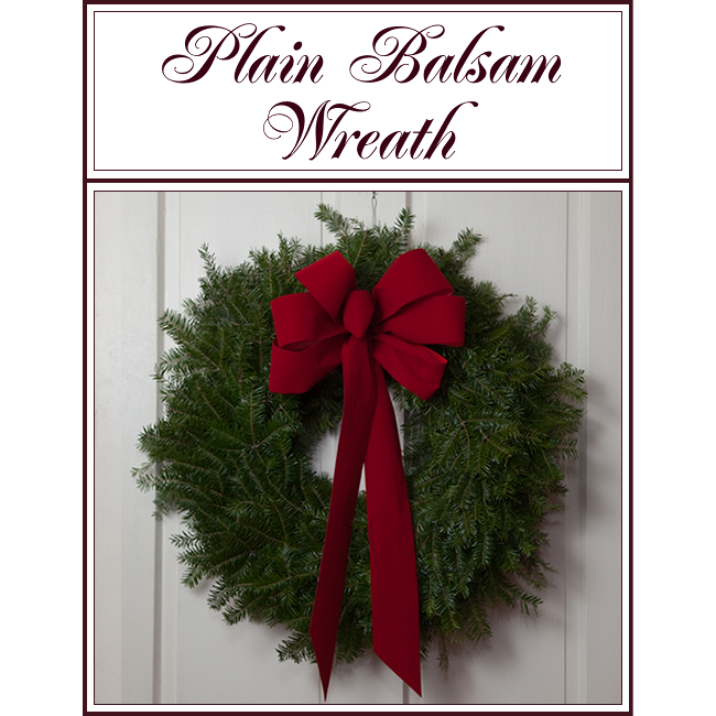 Plain balsam wreath with a large red bow and ribbon, shown against a light wall.