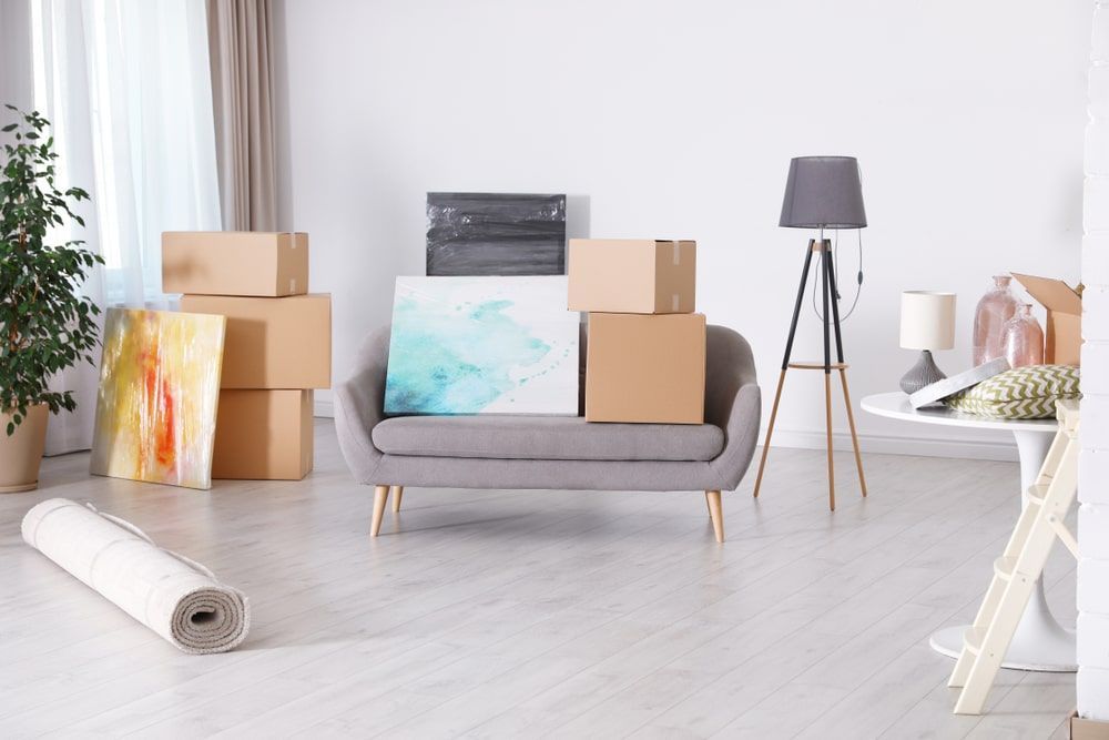 A Living Room Filled With Boxes And A Couch — Greater Newcastle Removals In Gwandalan, NSW