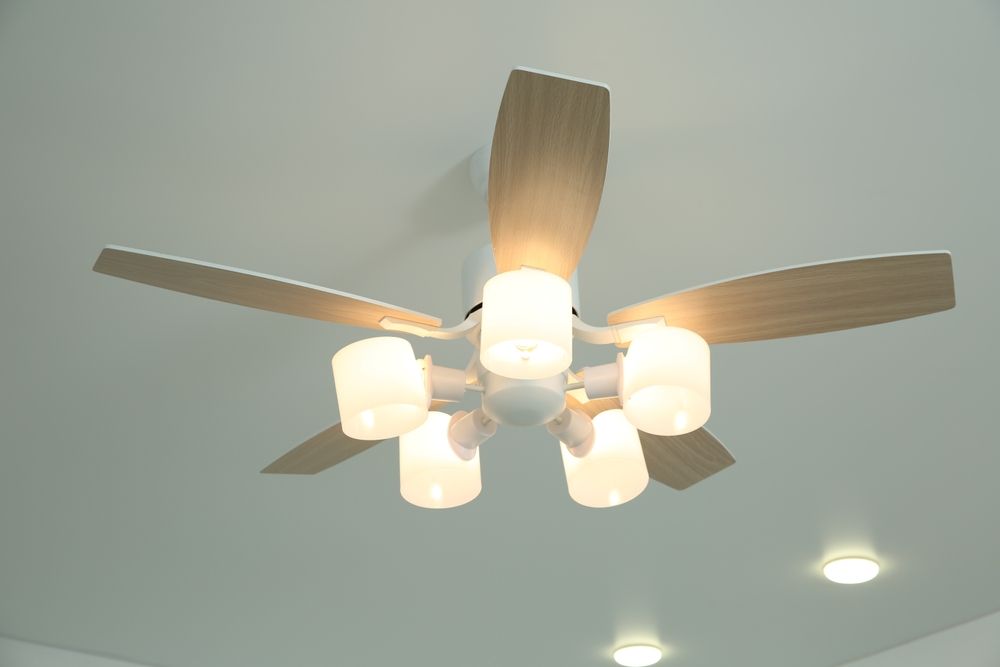 Wooden ceiling fan with five lights on a white ceiling