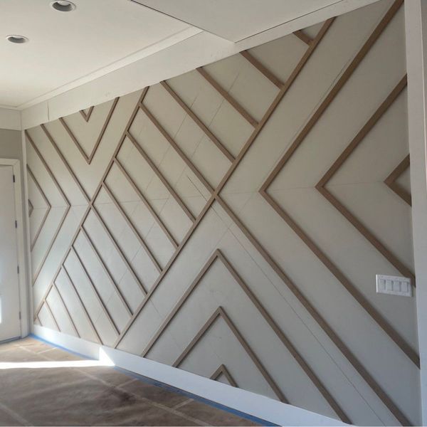 Geometric wood accent wall with beige and brown tones, in a room.