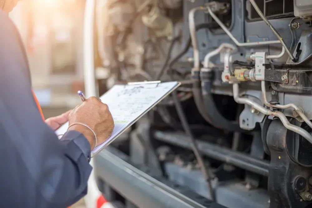 Mechanic Inspecting Vehicle Engine, Writing on a Clipboard — Advanced Auto Electrics & Mechanical in Innisfail, QLD