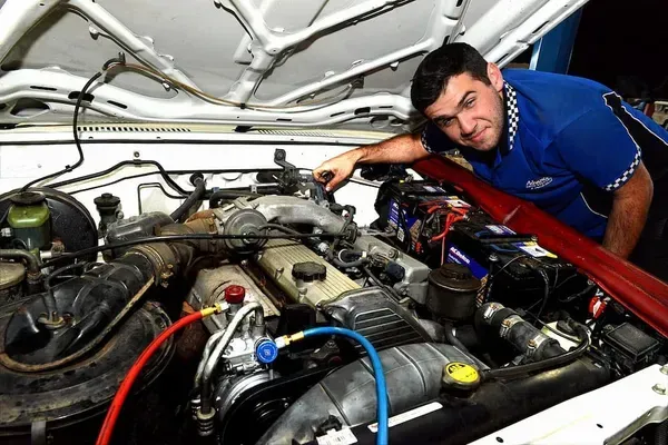 Mechanic Working on a Car Engine With Diagnostic Equipment — Advanced Auto Electrics & Mechanical in Innisfail, QLD