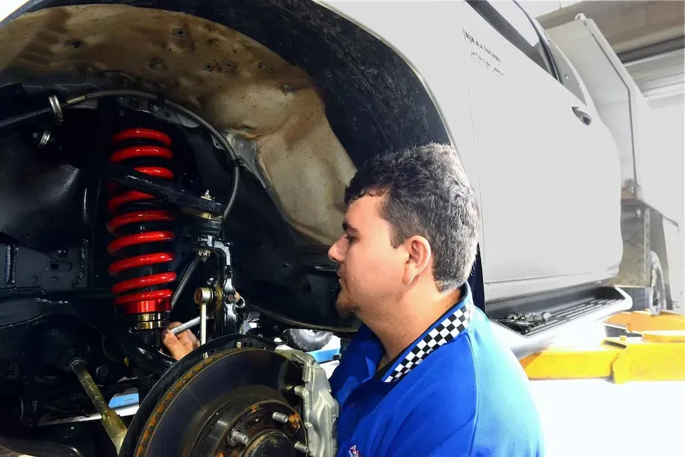 Mechanic Inspecting Suspension of a Vehicle — Advanced Auto Electrics & Mechanical in Innisfail, QLD