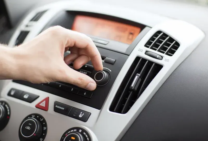 Hand Turning a Knob on a Car's Dashboard — Advanced Auto Electrics & Mechanical in Innisfail, QLD