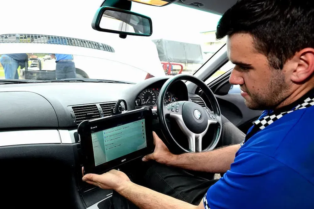 Man in a Car, Looking at a Tablet on the Dashboard — Advanced Auto Electrics & Mechanical in Innisfail, QLD