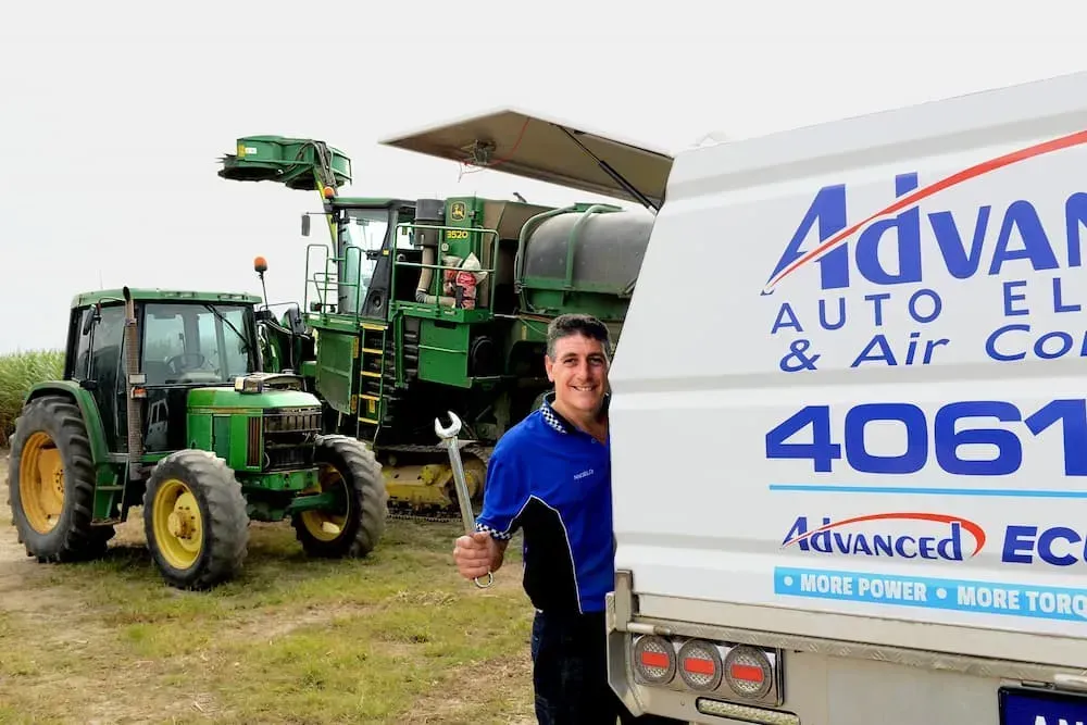 Man Holding a Wrench Smiles Next to a Service Van — Advanced Auto Electrics & Mechanical in Innisfail, QLD