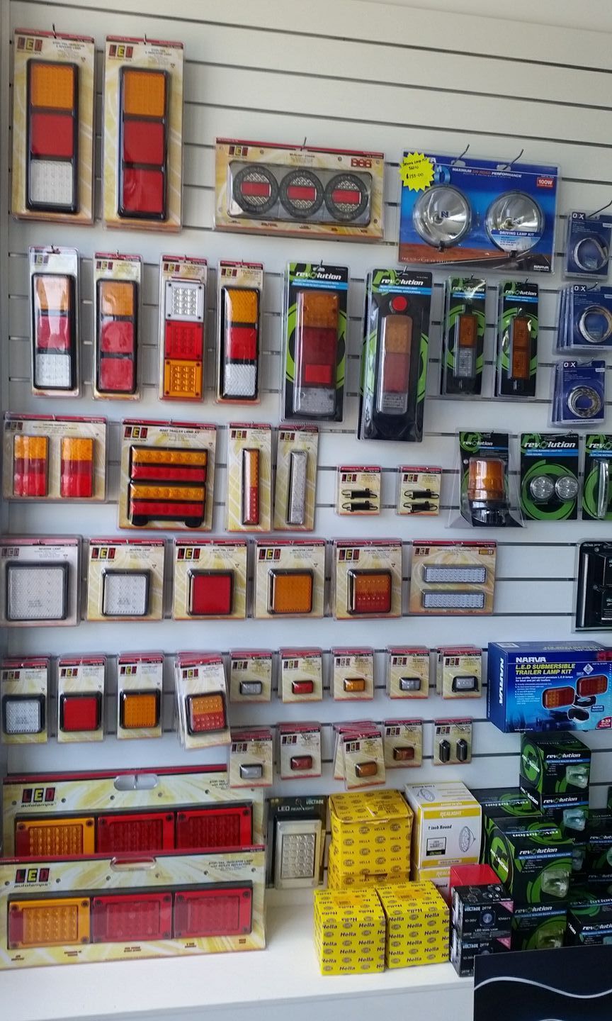 Shelves Displaying Various Vehicle Lights, Including Red — Advanced Auto Electrics & Mechanical in Innisfail, QLD