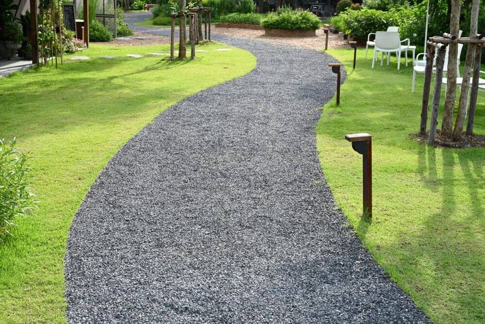 A Gravel Path Going Through A Lush Green Garden — Envy Landscape Supplies In Urangan, QLD