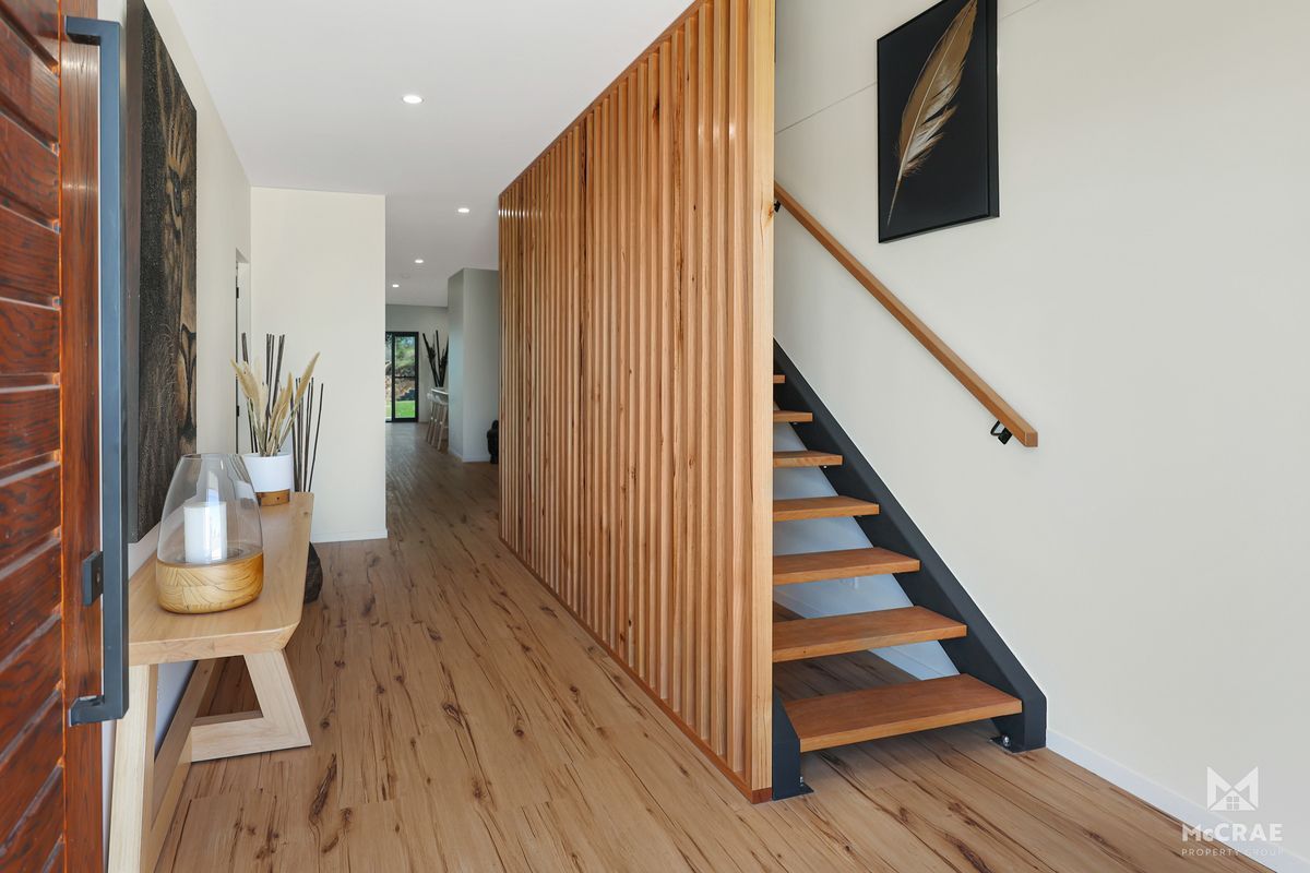 Wooden Slatted Wall Separates Hallway With Stairs, Wooden Flooring — Red Emperor Constructions in Cannonvale, QLD