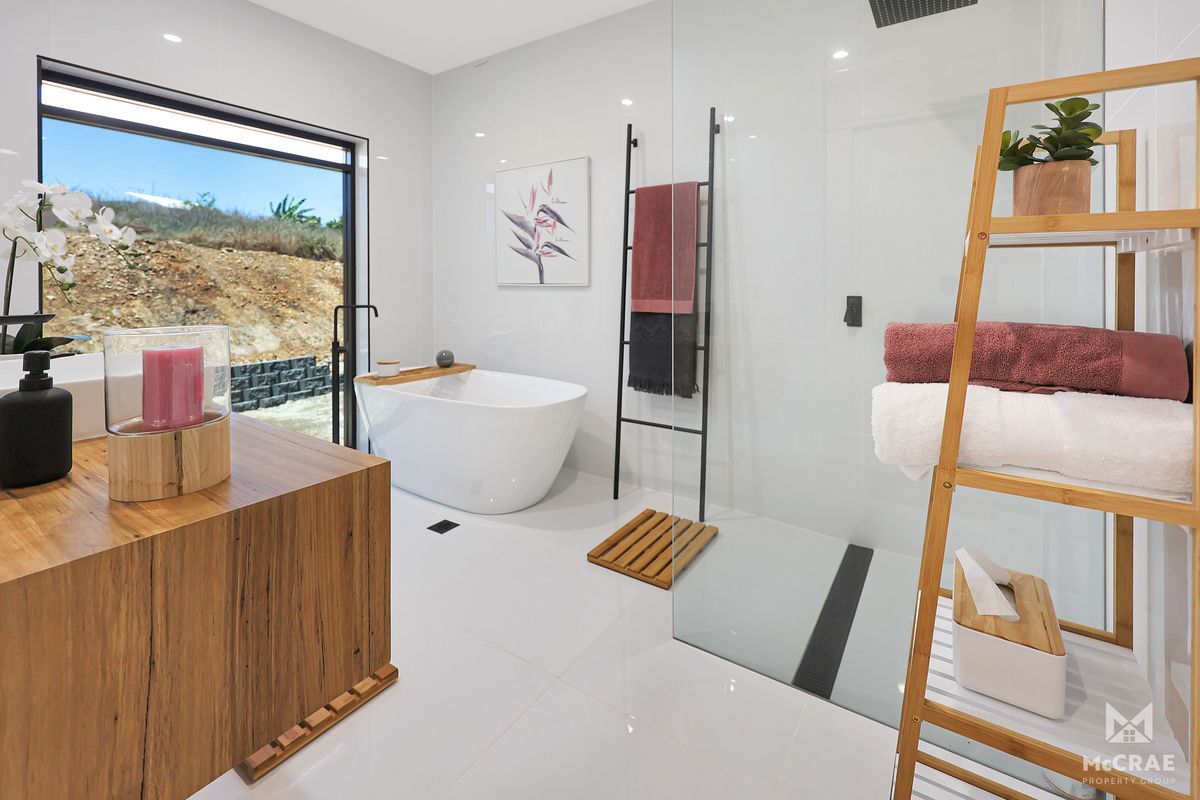 Modern White Bathroom With a Standalone Tub, Wood Accents — Red Emperor Constructions in Cannonvale, QLD
