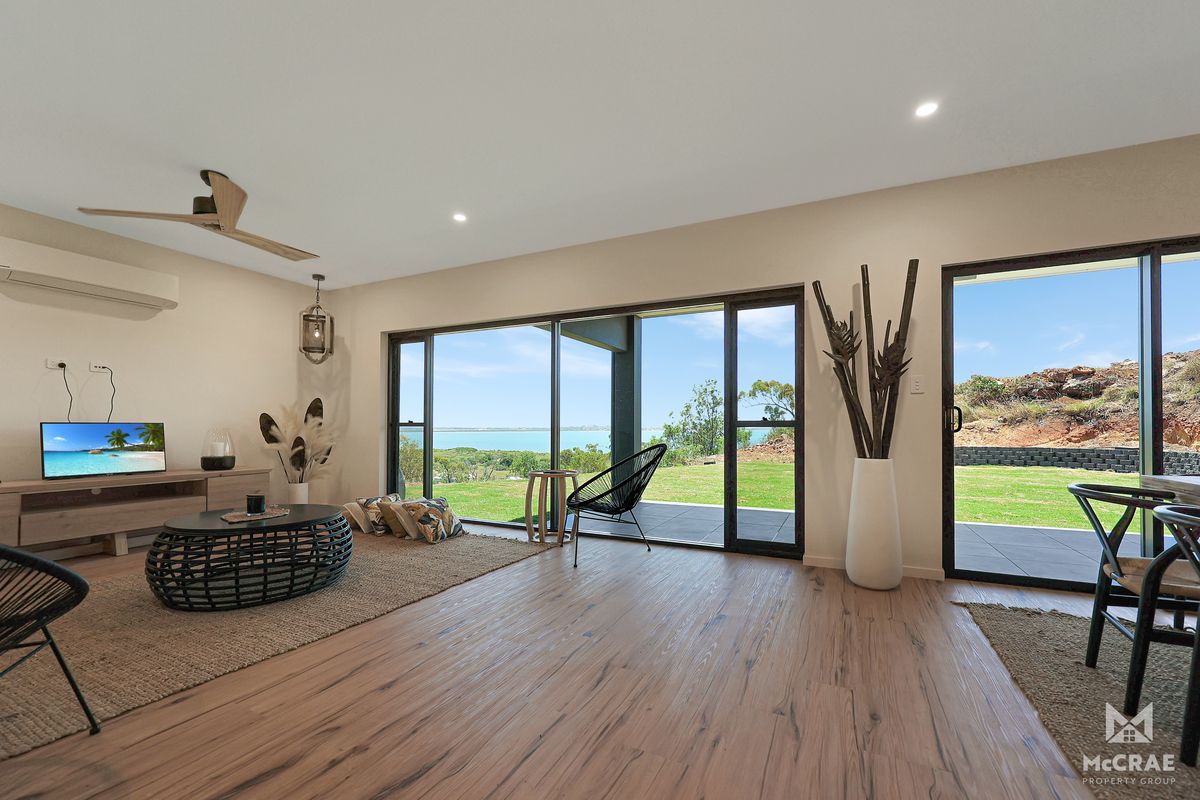 Living Room With Large Windows Overlooking Ocean View and Grassy Yard — Red Emperor Constructions in Cannonvale, QLD