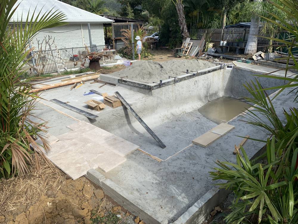 A swimming pool is being built in the backyard of a house — Red Emperor Constructions in Cannonvale, QLD