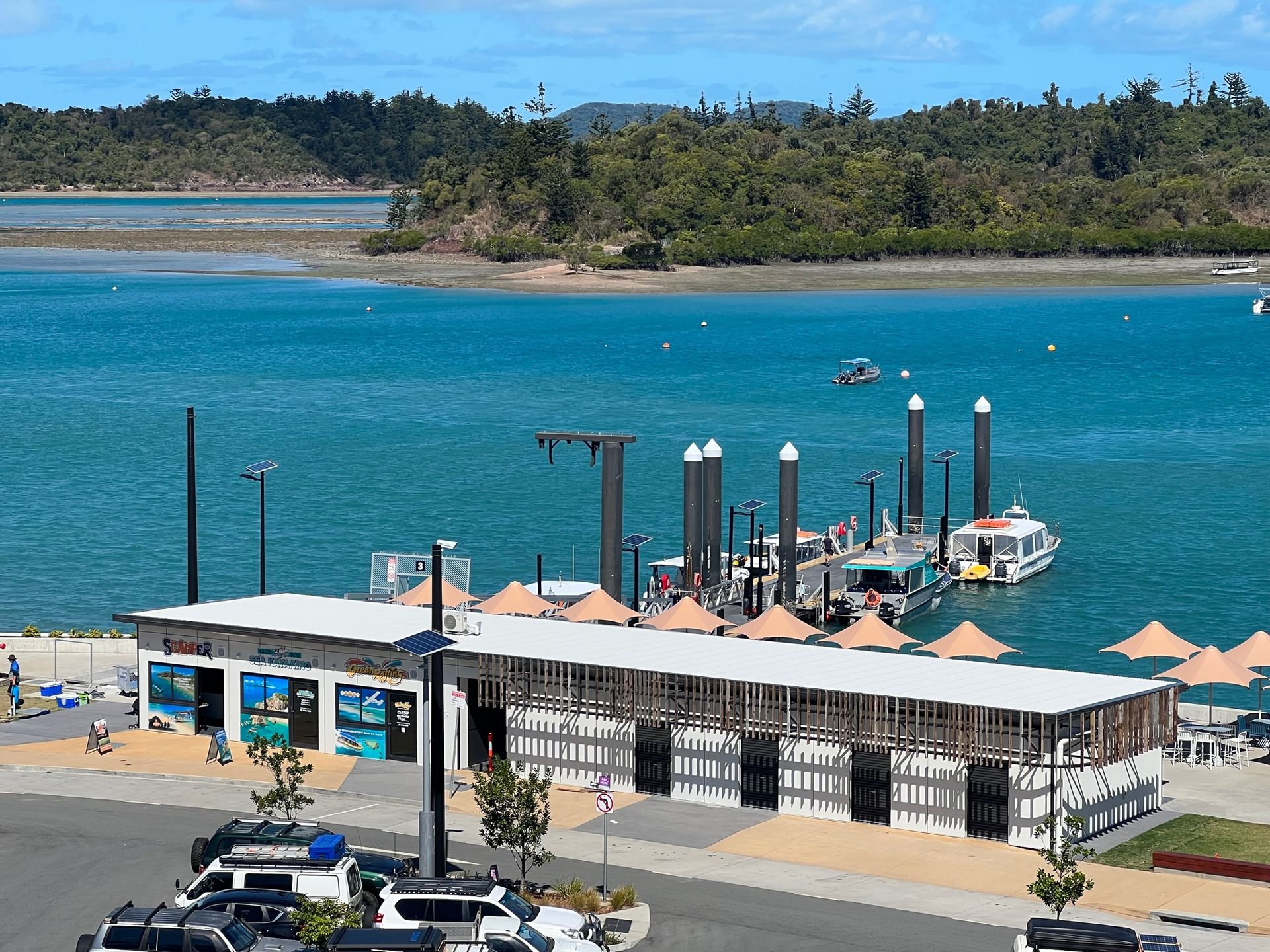 An aerial view of a dock with boats docked in the water — Red Emperor Constructions in Cannonvale, QLD