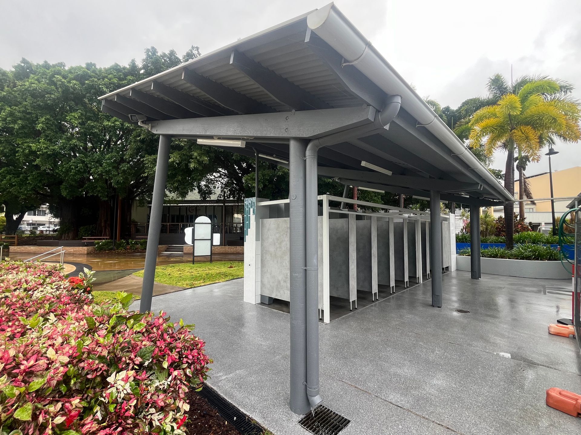 A row of toilet stalls under a canopy in a park — Red Emperor Constructions in Cannonvale, QLD