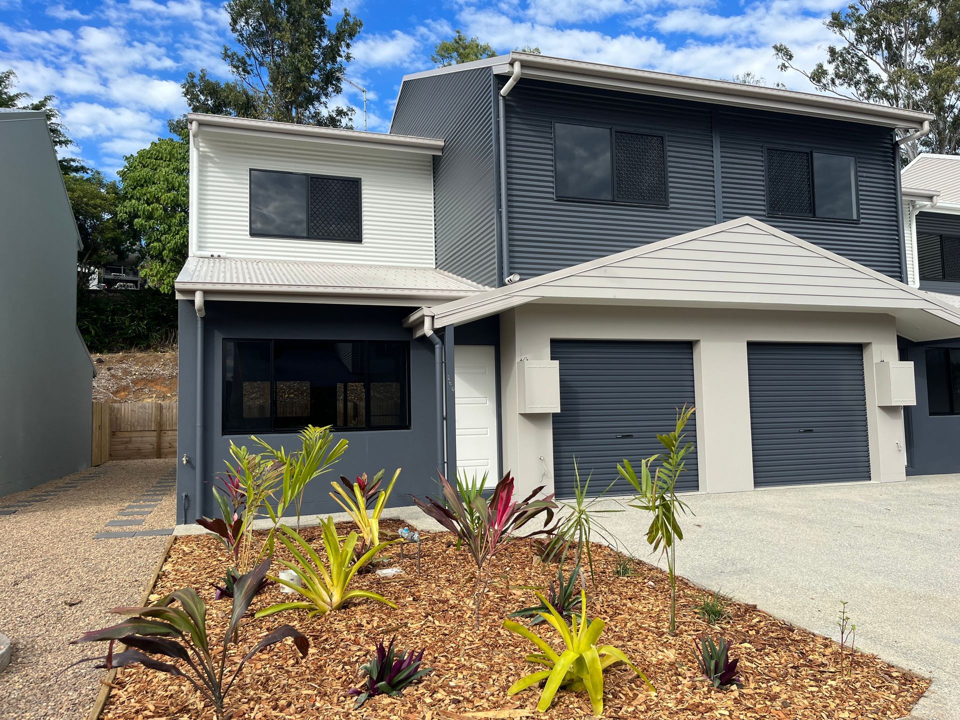 A White Car is Parked in Front of a White House — Red Emperor Constructions in Cannonvale, QLD