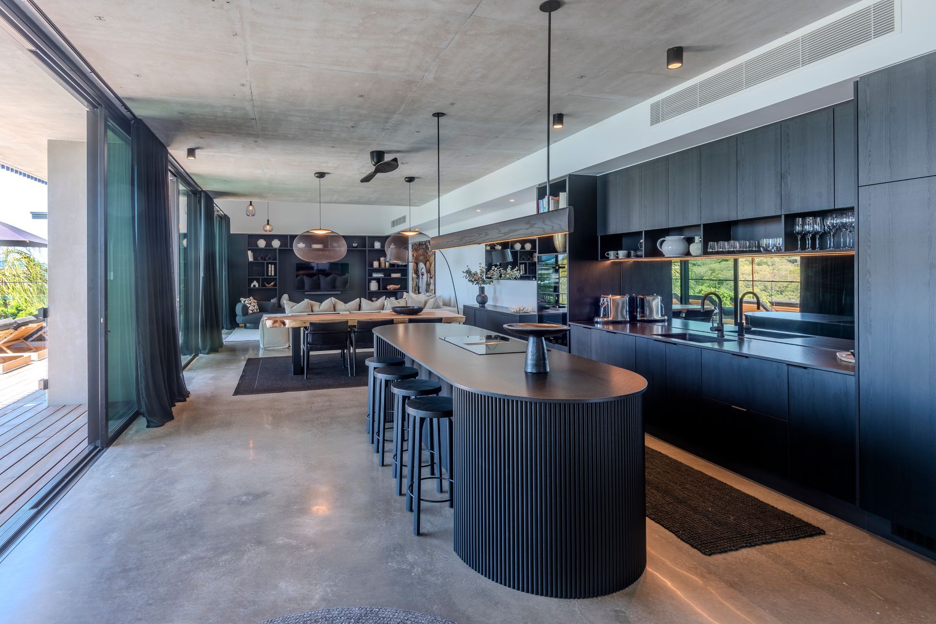 Modern Kitchen With a Large Island, Cabinets, and Open to the Dining Area — Red Emperor Constructions in Cannonvale, QLD