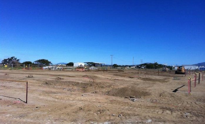 A large dirt field with a blue sky in the background — Red Emperor Constructions in Cannonvale, QLD