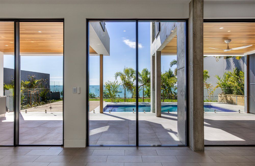 There is a swimming pool in the backyard of the house — Red Emperor Constructions in Cannonvale, QLD